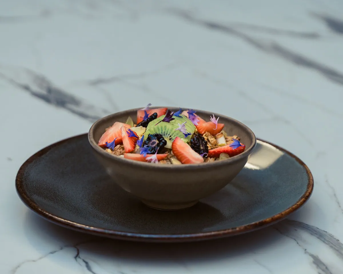 Bol de yaourt végétal garni de granola maison croustillant et de fruits frais